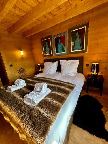 a bedroom with a large bed with towels on it at Unique, High-Design 6 Bedrooms Chalet in Villars Centre in Ollon