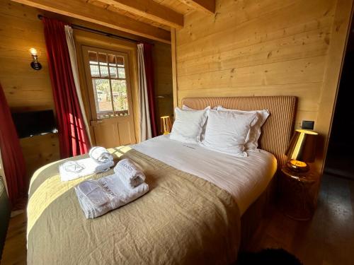a bedroom with a bed with towels on it at Unique, High-Design 6 Bedrooms Chalet in Villars Centre in Ollon
