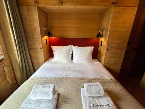 a bedroom with a bed with two towels on it at Unique, High-Design 6 Bedrooms Chalet in Villars Centre in Ollon