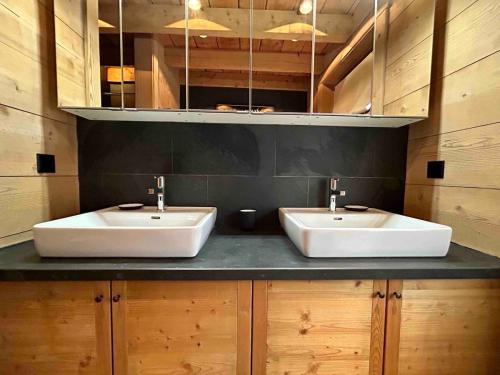two sinks on a counter in a bathroom at Unique, High-Design 6 Bedrooms Chalet in Villars Centre in Ollon