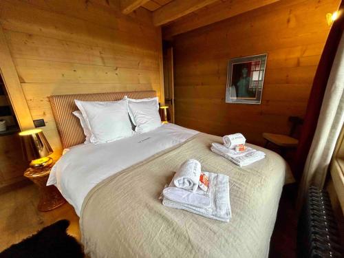 a bedroom with a bed with towels on it at Unique, High-Design 6 Bedrooms Chalet in Villars Centre in Ollon