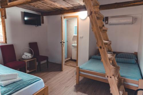 a room with two bunk beds and a ladder at Konak Dobri Potok in Krupanj