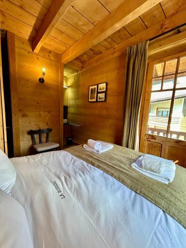 a bedroom with a large bed in a wooden room at Unique, High-Design 6 Bedrooms Chalet in Villars Centre in Ollon