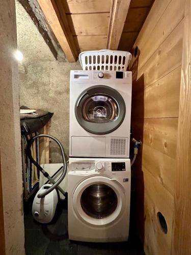a washing machine and a washer in a small room at Unique, High-Design 6 Bedrooms Chalet in Villars Centre in Ollon
