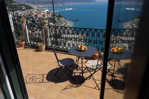 a balcony with two tables with fruit on them at La Tua Terrazza in Costiera in Albori