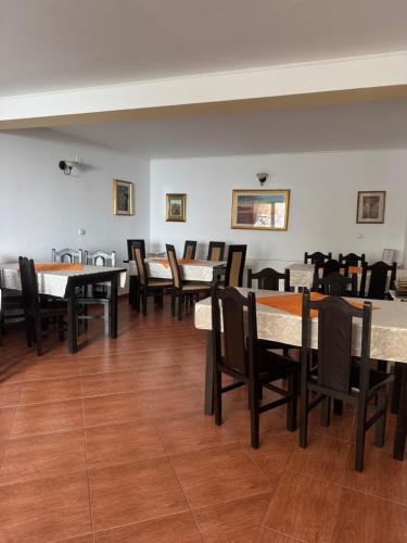 a dining room with tables and chairs at Casa Anastasia - Moieciu de Sus in Moieciu de Sus