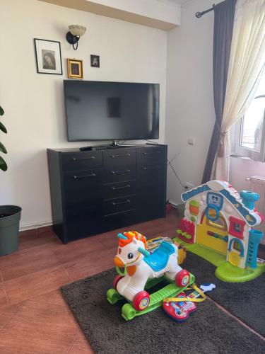 a living room with a toy horse and a tv at Casa Anastasia - Moieciu de Sus in Moieciu de Sus