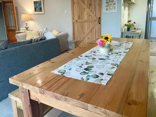 a wooden table with a table cloth on top of it at The Kite Manor in Langebaan