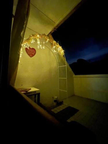 a room with a table and a heart on the wall at The Studio Apartment at Selesa Hillhomes Bukit Tinggi Bentong in Bentong