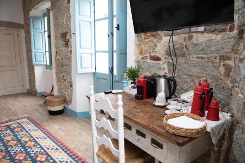 a room with a table with a coffee maker on it at B&B su Ponte in Orgosolo