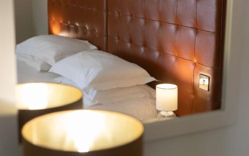 a reflection of a bed with pillows in a mirror at Heacham Manor Hotel in Hunstanton