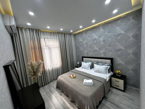 a bedroom with a large bed in a room at Spacious apartments in the center of Dushanbe in Isfisor
