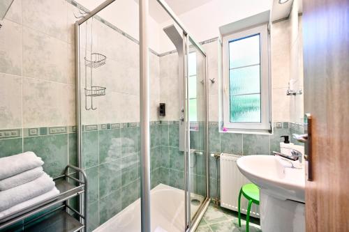 a bathroom with a shower and a sink at Wellness Hotel Fénix in Liberec