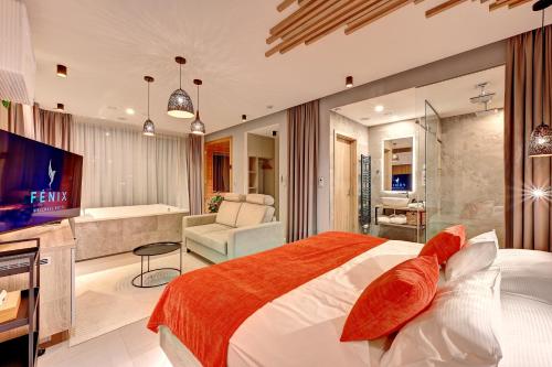 a bedroom with a bed and a living room at Wellness Hotel Fénix in Liberec