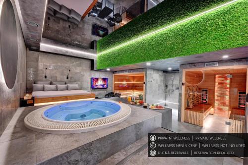 a bathroom with a jacuzzi tub in the middle at Wellness Hotel Fénix in Liberec