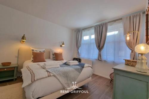 a bedroom with a large bed and a window at La Symphonie Elevator Honfleur City Center 2 Guests in Honfleur