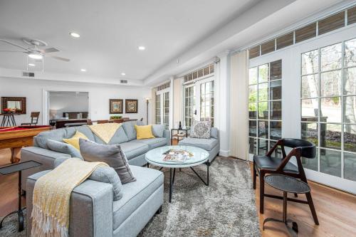 a living room with a couch and a table at The Clubhouse Hideaway - The Greenview Den in Chapel Hill