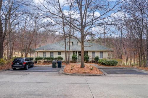 a car parked in front of a house at The Clubhouse Hideaway - The Greenview Den in Chapel Hill