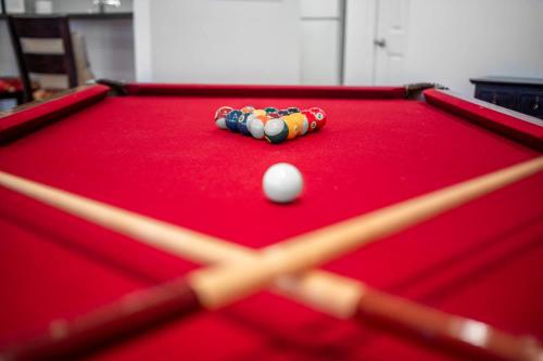 a cue ball on top of a pool table at The Clubhouse Hideaway - The Greenview Den in Chapel Hill