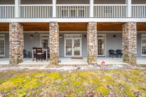 a porch of a house with a table and chairs at The Clubhouse Hideaway - The Greenview Den in Chapel Hill