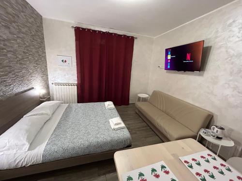 a hotel room with a bed and a couch at Guest House Il Faraone in Fiumicino