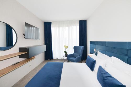 a hotel room with a large bed and a mirror at Art Plaza Hotel in Sofia