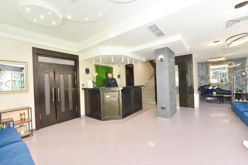 a living room with a man standing at a counter at Art Plaza Hotel in Sofia