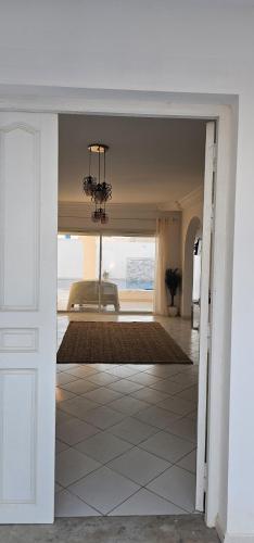 a hallway with a view of a living room with a chandelier at Villa Narjess in Taguermess