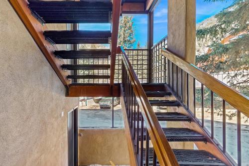 a staircase in a house with a glass window at Lake Fork 10 in Taos Ski Valley