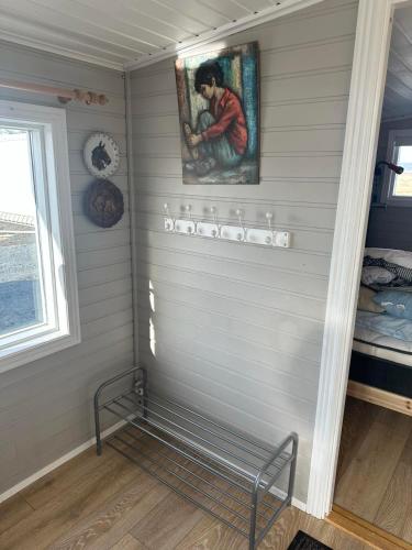 a corner of a room with a painting on the wall at Cozy Kálfhóll in South Iceland in Hraunvellir