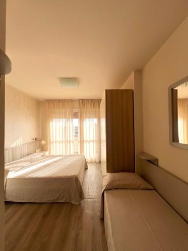 a bedroom with a large bed and a window at Hotel Nuova Sabrina in Marina di Pietrasanta