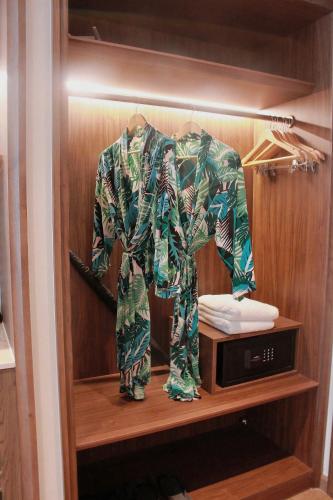 a robe on a shelf next to a microwave at Apec Mandala Mũi Né Sun Sea Condotel in Mui Ne
