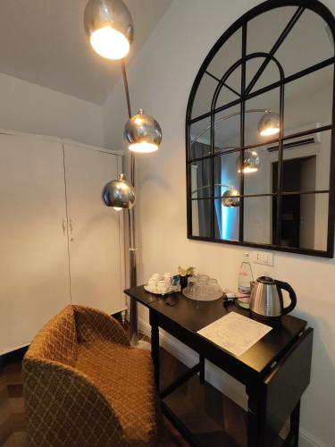 a room with a table and a chair and a mirror at Botanica Loft in Montichiari Airport
