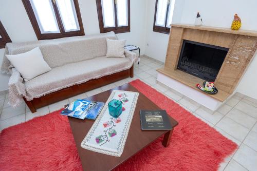 a living room with a couch and a fireplace at Zmas Studios in Chorto