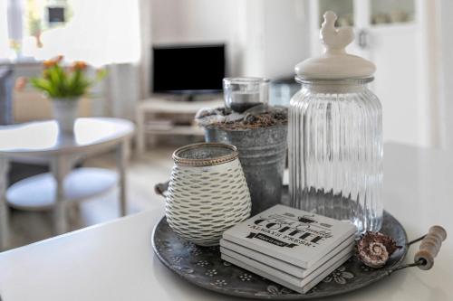 a table with a plate with a bottle and a book at Ferienhaus Nilsson in Heide