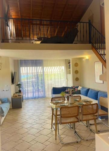 a living room with a blue couch and a table at Only Blue Villa in Karianí