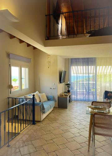 a living room with a couch and a tv at Only Blue Villa in Karianí