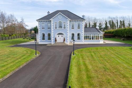 a large white house with a large driveway at Mongalvin in Whitehill