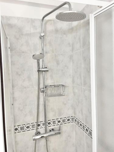 a shower with a shower head in a bathroom at Copacobana Ocean View Playa Las Americas in Costa de Adeje