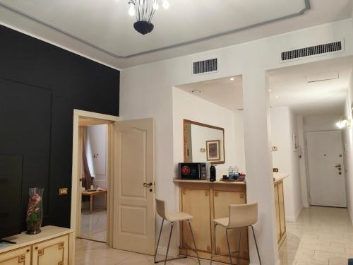 a living room with two chairs and a table at Aparthotel Dei Mercanti in Milan