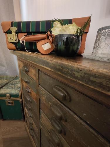 a wooden dresser with a bowl on top of it at Botanica Loft in Montichiari Airport