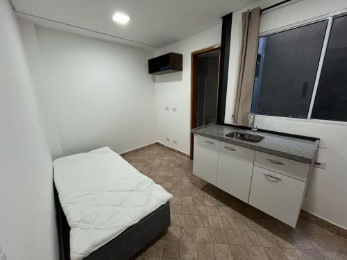 a small room with a bed and a sink at Condomínio Residencial Vitória 3 in Sao Paulo