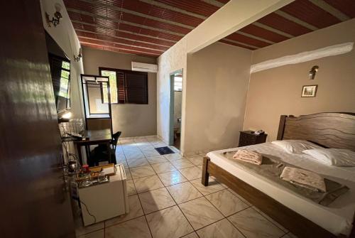 a bedroom with a bed and a chair in a room at Hotel Primavera in Aramina
