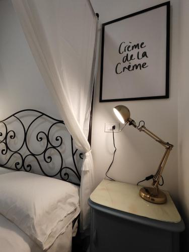 a bedroom with a bed and a lamp on a night stand at Botanica Loft in Montichiari Airport