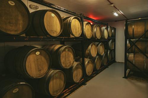 a row of wine barrels in a cellar at Hotel Boutique Vinícola Araucária by Slaviero Hotéis in São José dos Pinhais