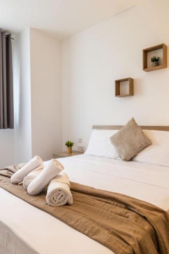 a bedroom with a bed with towels on it at Stunning 2BR Apartment in Sliema - APT 23 in Sliema