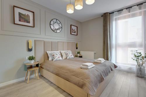 Ένα ή περισσότερα κρεβάτια σε δωμάτιο στο Staywin Apartments Chmielna Park