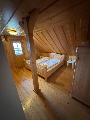 a view of a bedroom in a wooden house at Pension Tereza & Šumavské Roubenky in Sušice