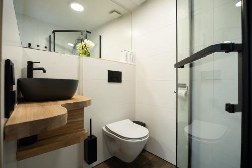 a bathroom with a sink and a toilet at 4 Bedroom House with Playground, BBQ & Free Parking in Rīga
