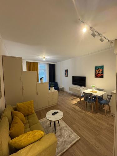 a living room with a couch and a table at Moonlight Apart-Hotel Batumi in Batumi
